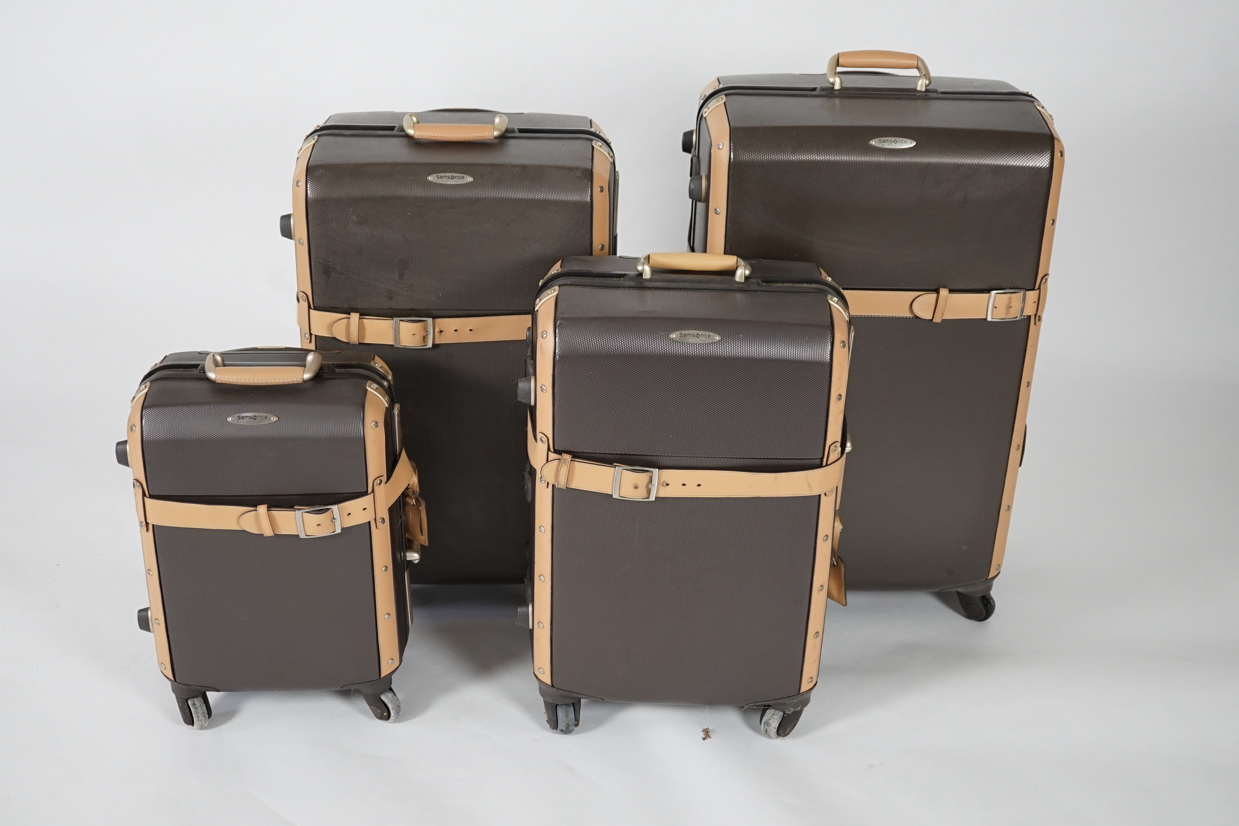 A graduated set of four Samsonite Black Label brown and tan hard suitcases, 83cm x 52cm x 34cm, 77cm x 48cm x 30cm, 66cm x 43cm x 27cm, 53cm x 36cm x 22cm